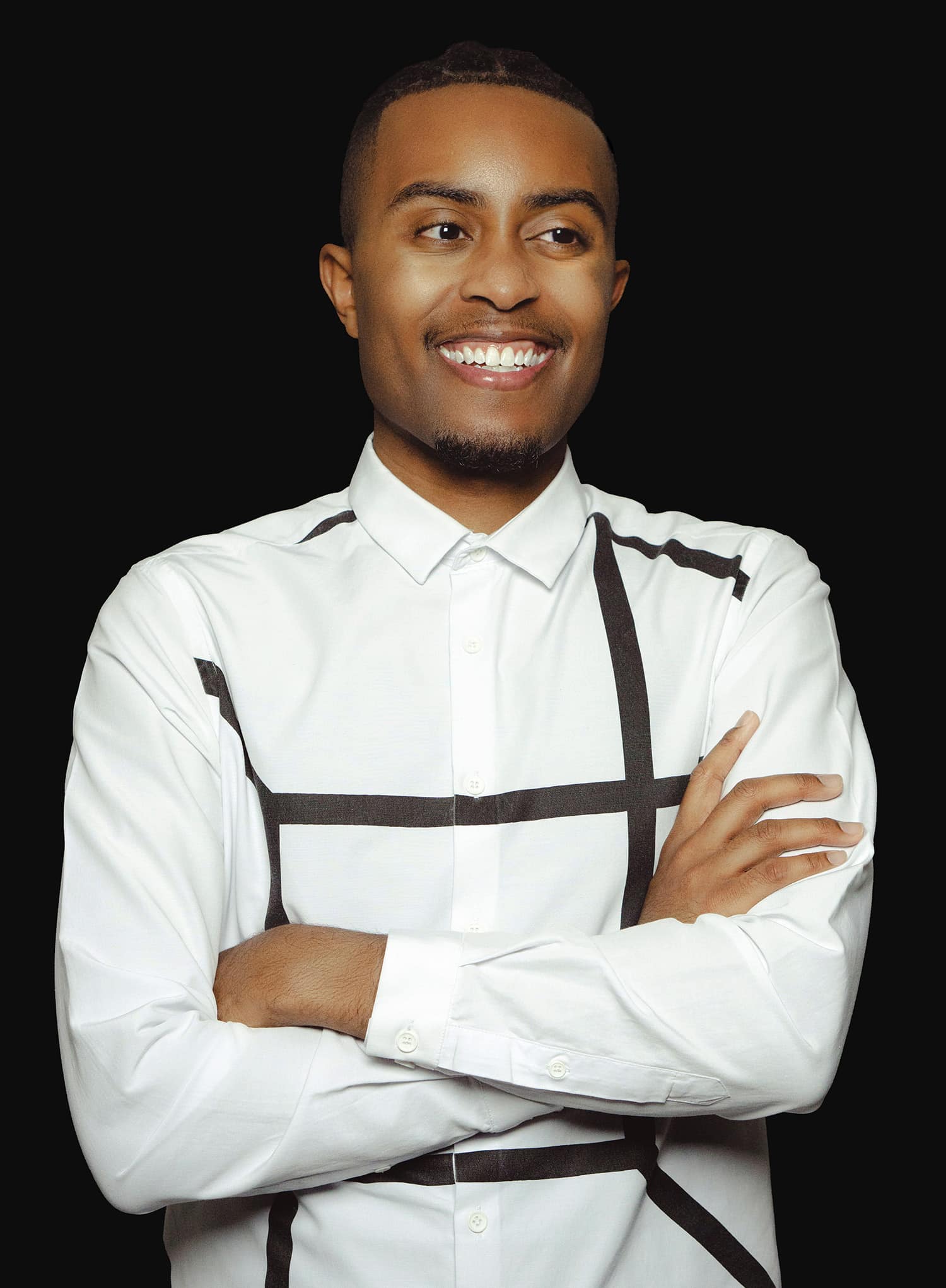 Photo of man smiling with his arms folded